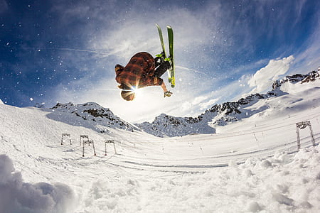 person wearing orange and black plaid shirt playing ice ski thumbnail