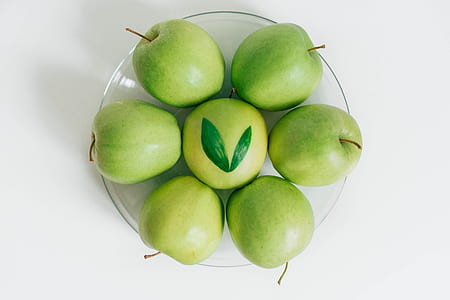 seven green apples on clear glass plate thumbnail