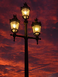 three lighted black and yellow lamp post thumbnail
