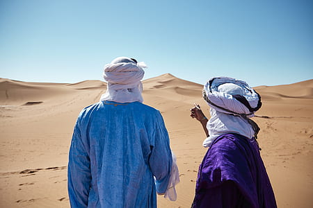 two person facing desert dune thumbnail