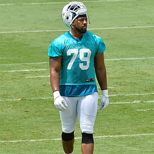 football player walking on field thumbnail