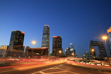 high-rise buildings during nighttime with road in vicinity thumbnail