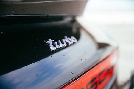 Rear view of a black sports car with Turbo detail thumbnail
