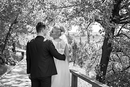 Bride and Groom About to Kiss Standing Under Tree thumbnail