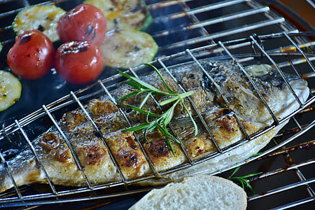 grilled fish and tomatoes on top of grill thumbnail