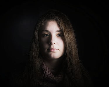 woman standing in dark thumbnail