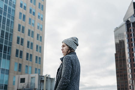 woman standing in the middle of buildings thumbnail