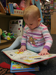 baby sitting while reading storybook thumbnail