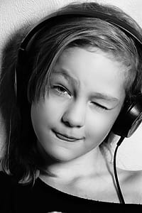 grayscale photo of girl wink left eye and wearing headpohnes thumbnail