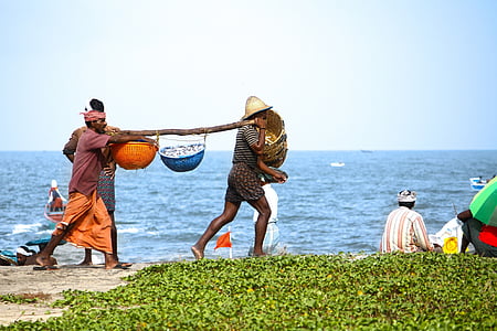 two men carrying wooden yoke with two baskets thumbnail