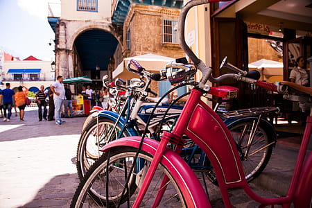 Red Beach Cruiser Bicycle Across Concrete Building thumbnail