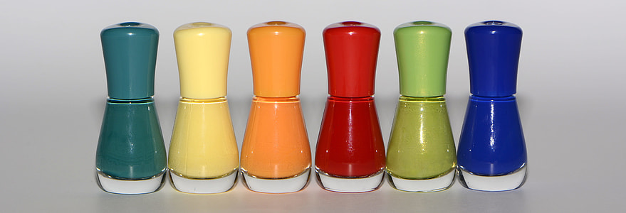 six assorted-color bottles on glass surface thumbnail