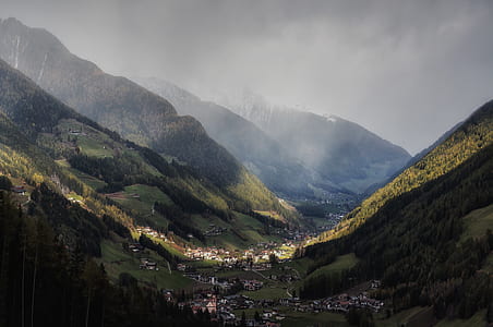 high angle photography of village on base of mountain thumbnail