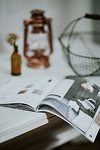 Magazine with a paraffin lamp on a white table thumbnail