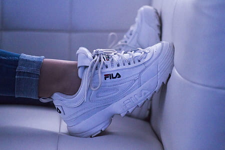 photo of person wearing white FILA running shoes thumbnail