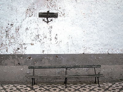 black metal bench beside wall thumbnail