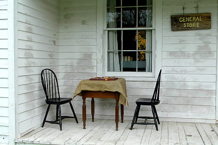 two black windsor chairs in front of window thumbnail