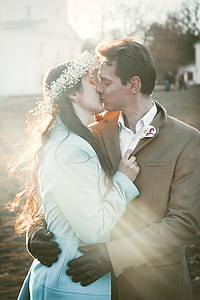 woman and man kissing during daytime thumbnail