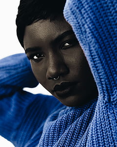 woman wearing blue knit long-sleeved shirt thumbnail
