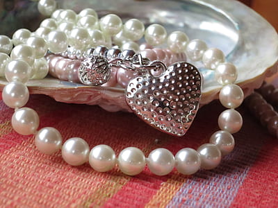 pearl beaded silver-colored heart pendant necklace on gray shell thumbnail