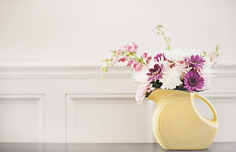 white and purple flowers on beige ceramic vase thumbnail