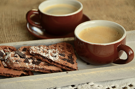 brown and white ceramic teacup near biscuits thumbnail