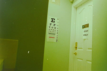eye chart on wall beside close door thumbnail