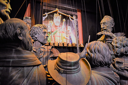 group of statuette watching puppet show thumbnail