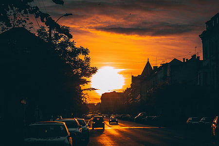 cars running on road during sunset thumbnail