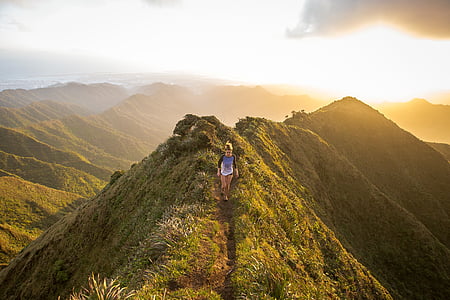 person walking on mountain during golden hour thumbnail
