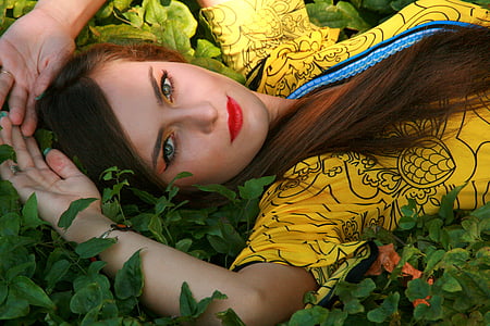 woman lying on green leaf plants thumbnail