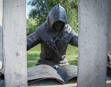 black metal man figure near tree thumbnail