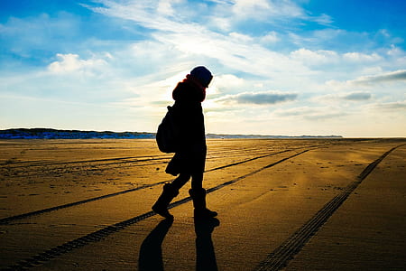 silhouette of person walking on desert thumbnail
