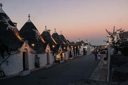 two person standing beside houses thumbnail