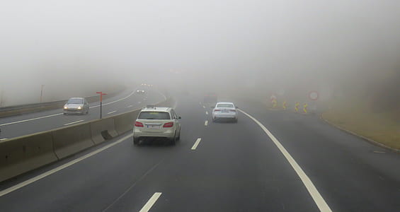 grey and white vehicle speeding on road with fogs thumbnail