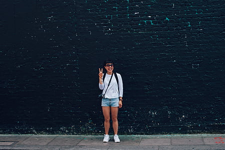 woman smiling and raising right hand thumbnail