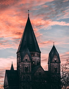 brown cathedral under orange and blue sky during golden hour thumbnail