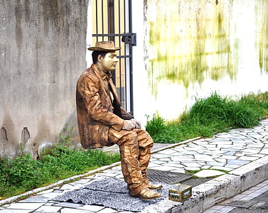 man in brown suit sitting thumbnail
