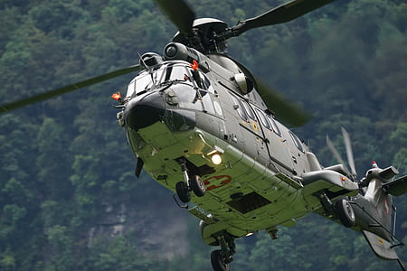 green helicopter flying during daytime thumbnail