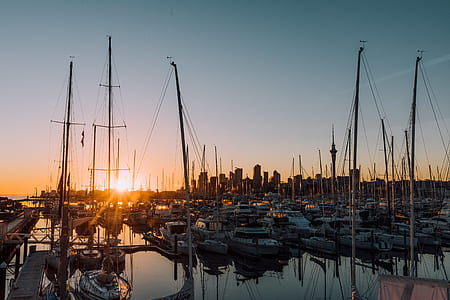 white docked boats during golden hour thumbnail