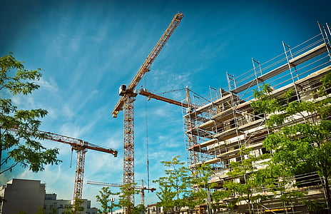 brown and white building under white and blue sky thumbnail