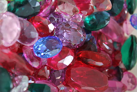 assorted-color gemstone lot on brown surface thumbnail