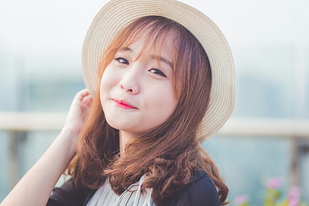 girl holding her hat thumbnail