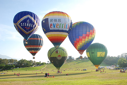 six assorted-color hot air balloons in mid air thumbnail