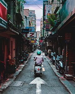 boy riding on white motor scooter thumbnail