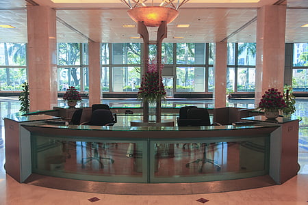 empty glass-top front desk in the lobby of a building thumbnail