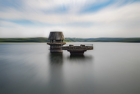 brown shed at the middle of the ocean during day time thumbnail