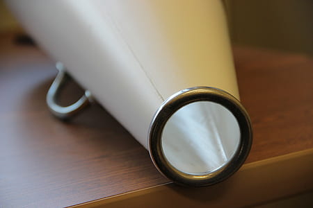 white cheerleader horn on brown wooden table thumbnail