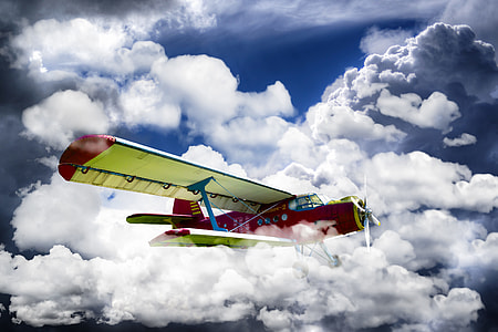 red and white plane flying on sky at daytime thumbnail