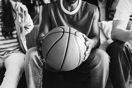 Grayscale Photography of Person Holding Basketball thumbnail